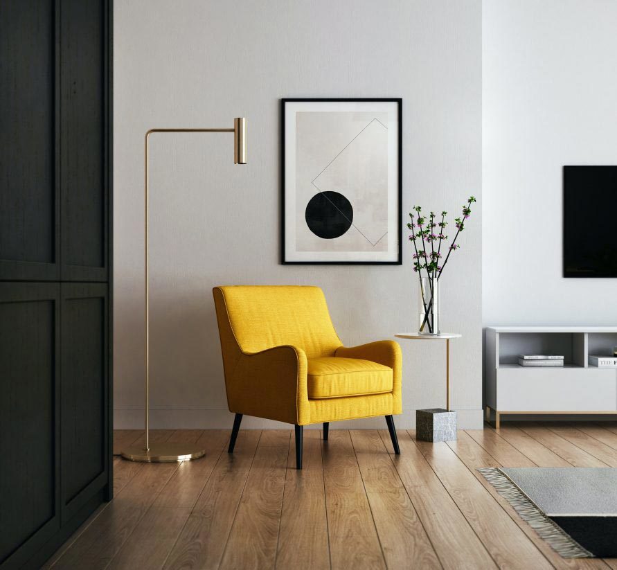 Esquina de un salón minimalista con una propuesta en neutros combinados con un sillón amarillo